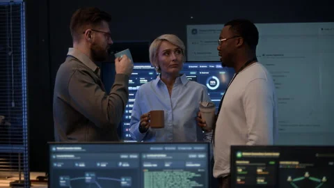 Team of Cybersecurity Engineers Communicating during Coffee Break in Office Stock Footage 334934834