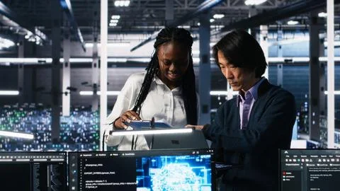 Team of data center engineers using machine learning algorithms Stock Photos