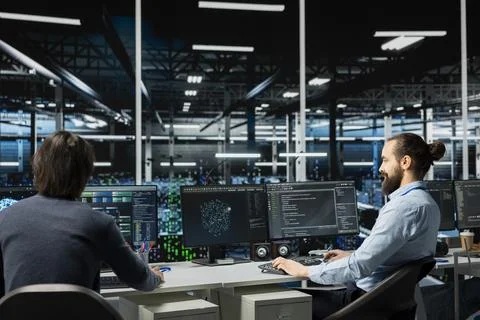 Team of data center programmers working together in office, managing AI systems Stock Photos