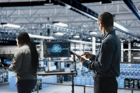 Team of data center software developers review code for AI automation scripts 库存照片