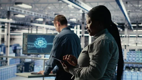 Team of data center technicians checks AI dashboard using laptop Stock Footage 314804884