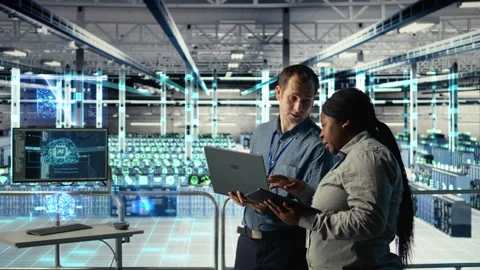 Team in data center uses AR simulation to visualize AI systems, VFX compositing Stock Footage 323830130