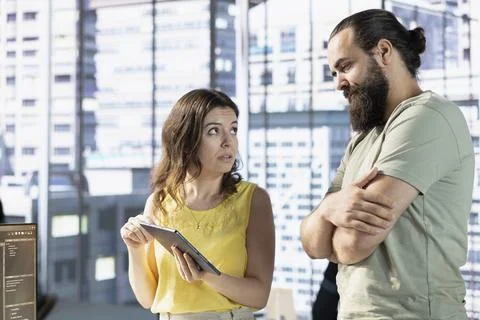 Team of data science workers conducting code review on tablet to fix bugs Stock Photos