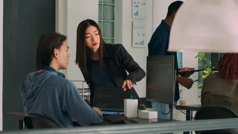 Team of database admins analyzing source code on computer monitor Stock Footage 219899919