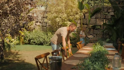 Team of decorators create summer garden party setup outdoor wedding at tropical Stock Footage 250840209