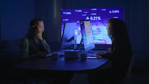 The team is deeply engaged in analyzing complex data using hightech Stock Footage 293402169