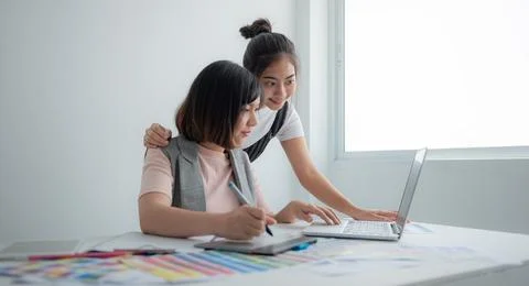 Team Designer using laptop to design fashion clothes. Stock Photos
