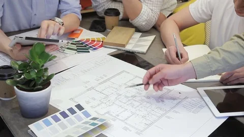 Team of designers work sitting at table in office using tablet. Stock Footage 83027180