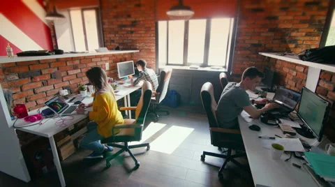Team of designers working on computer together in their office Видео 64858173