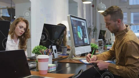 Team at desk, man moving mouse causing globe overlay linking pie chart for Stock Footage 334322134