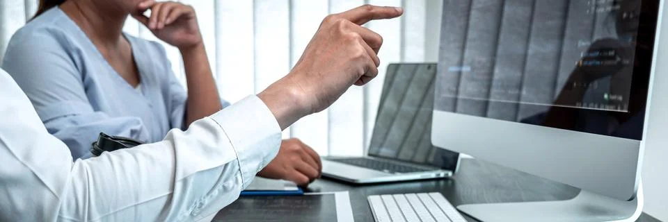 Team of Developer programmer working on coding program software computer in o Stock Photos