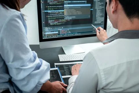 Team of Developer programmer working on coding program software computer in o Stock Photos