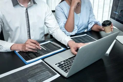 Team of Developer programmer working on coding program software computer in o Stock Photos