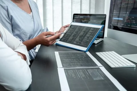 Team of Developer programmer working on coding program software computer in o Stock-Fotos