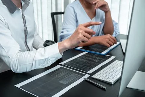 Team of Developer programmer working on coding program software computer in o Stock Photos