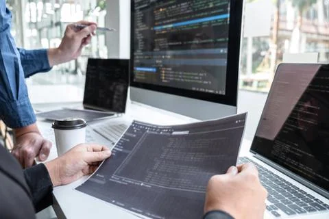 Team of developer programmer working on project in software development compu Stock Photos