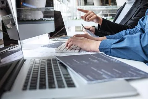 Team of developer programmer working on project in software development compu Stock Photos