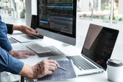 Team of developer programmer working on project in software development compu Stock Photos
