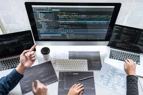 Team of developer programmer working on project in software development compu Stock Photos