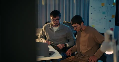 Team of Developers Collaborating in a Night Office Environment. Stock Footage 306739059