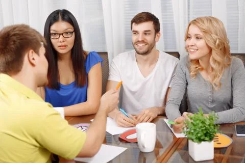 Team of developers making notes and discussing the project Stock Photos