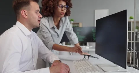 Team of developers reviewing code on computer monitor in office, teamwork Video stock 337929362