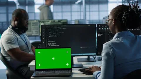 Team of developers in server hub using green screen laptop Stock Photos