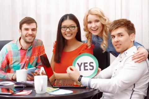 Team of developers showing icons Stock Photos