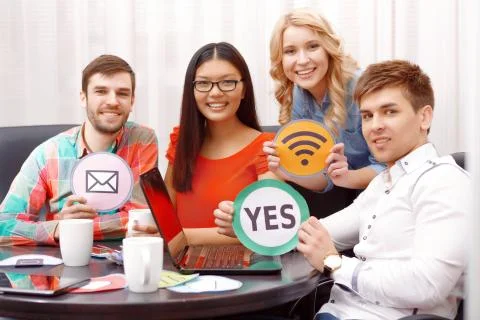Team of developers showing icons Stock Photos