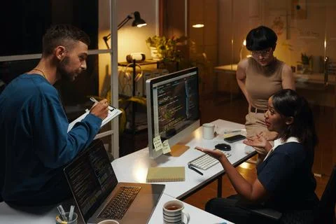 Team of Developers Working Late 스톡 사진