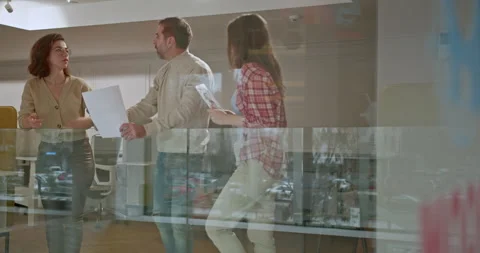 Team of different aged office workers brainstorming on a project, emphasizing Stock Footage 277291746