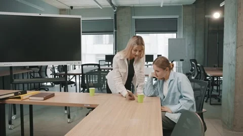 Team discusses project details in modern office setting 動画素材 318521198