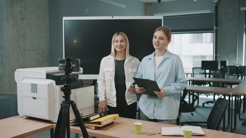 Team discusses project ideas in office with printer and camera setup Stock Footage 326324465