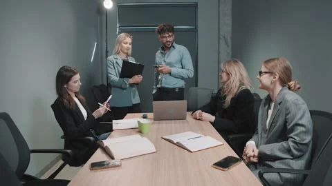 Team discusses project updates in an office setting Video stock 326324983