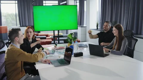 The team discusses projects in the office while sitting at the table Stock Footage 193982060