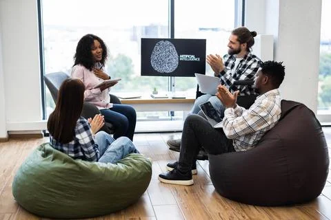 Team Discussing Artificial Intelligence with Enthusiastic Applause in Office Stockfoto's