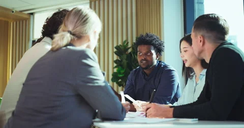 Team discussing innovative project in modern office Stock Footage 306094884