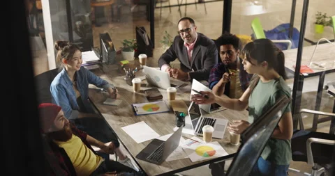 Team of diverse creative developers doing a highfive while discussing marketing Stock Footage 162524116