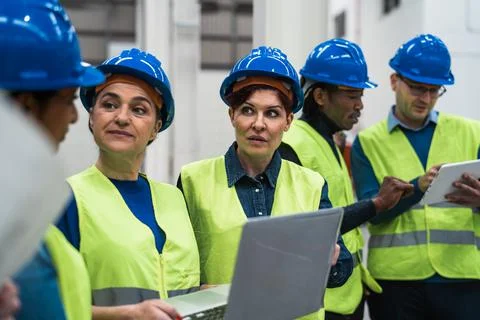 Team of diverse engineers working in robotic factory - Tech industrial concept 스톡 사진