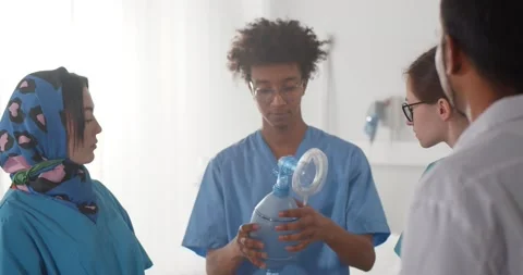 Team of diverse medical interns learning how to use breathing bag Stock Footage 150620660