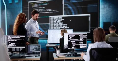 Team of diverse software engineers coding on desktop computers 스톡 사진