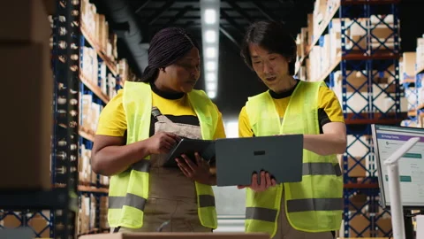 Team of diverse workers handling tracking software for parcel status on tablet 스톡 동영상 312838526