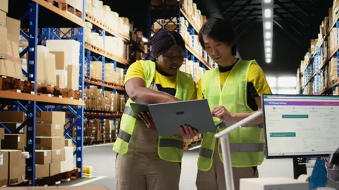 Team of diverse workers handling tracking software for parcel status on tablet Stock Footage 313090702
