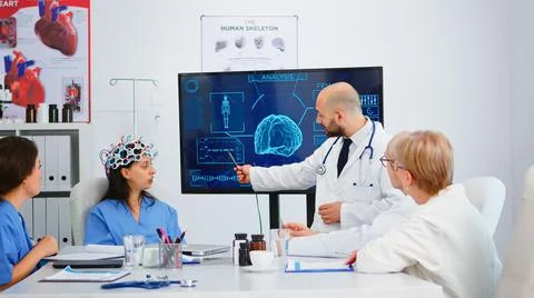 Team of doctors analysing brain functions using high tech 写真素材