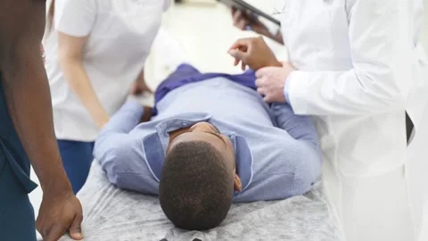 Team of doctors checking state of health of urgently admitted patient Stock Footage 150728195