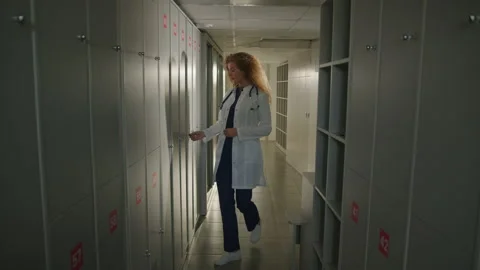 A team of doctors communicate at the end of the working day in the locker room Stock Footage 238740037