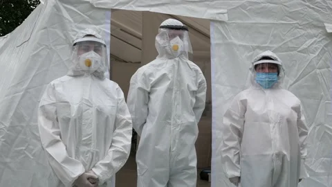 A team of doctors in Covid-19 protective suits at a field hospital Stock-Footage 156512538