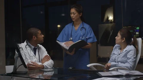 Team of doctors discussing over skull radiology in hospital lab Stock Footage 106737956
