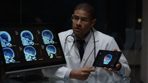 Team of doctors discussing over skull radiology in hospital lab Stock Footage 106738600