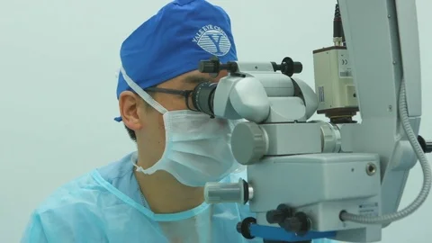 Team of doctors during an eye surgery Stock Footage 77449493